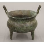 A Chinese three footed bronze censer. 11.5 cm high x 13 cm across handles (10.5 cm inner diameter).