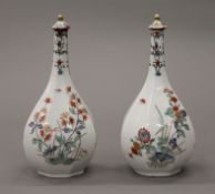 A pair of 18th/19th century kakiemon palette bottle vases with lids. 19 cm high.