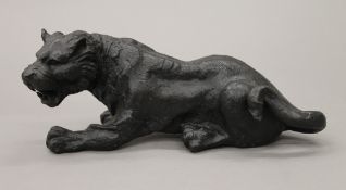A patinated bronze model of a tiger. 26 cm long.