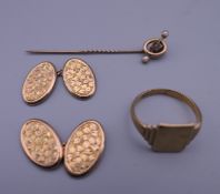 A 9 ct gold signet ring, a pair of engraved 9 ct gold cufflinks and a 9 ct gold stickpin.