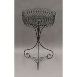 A Victorian wire work plant stand. 82 cm high.