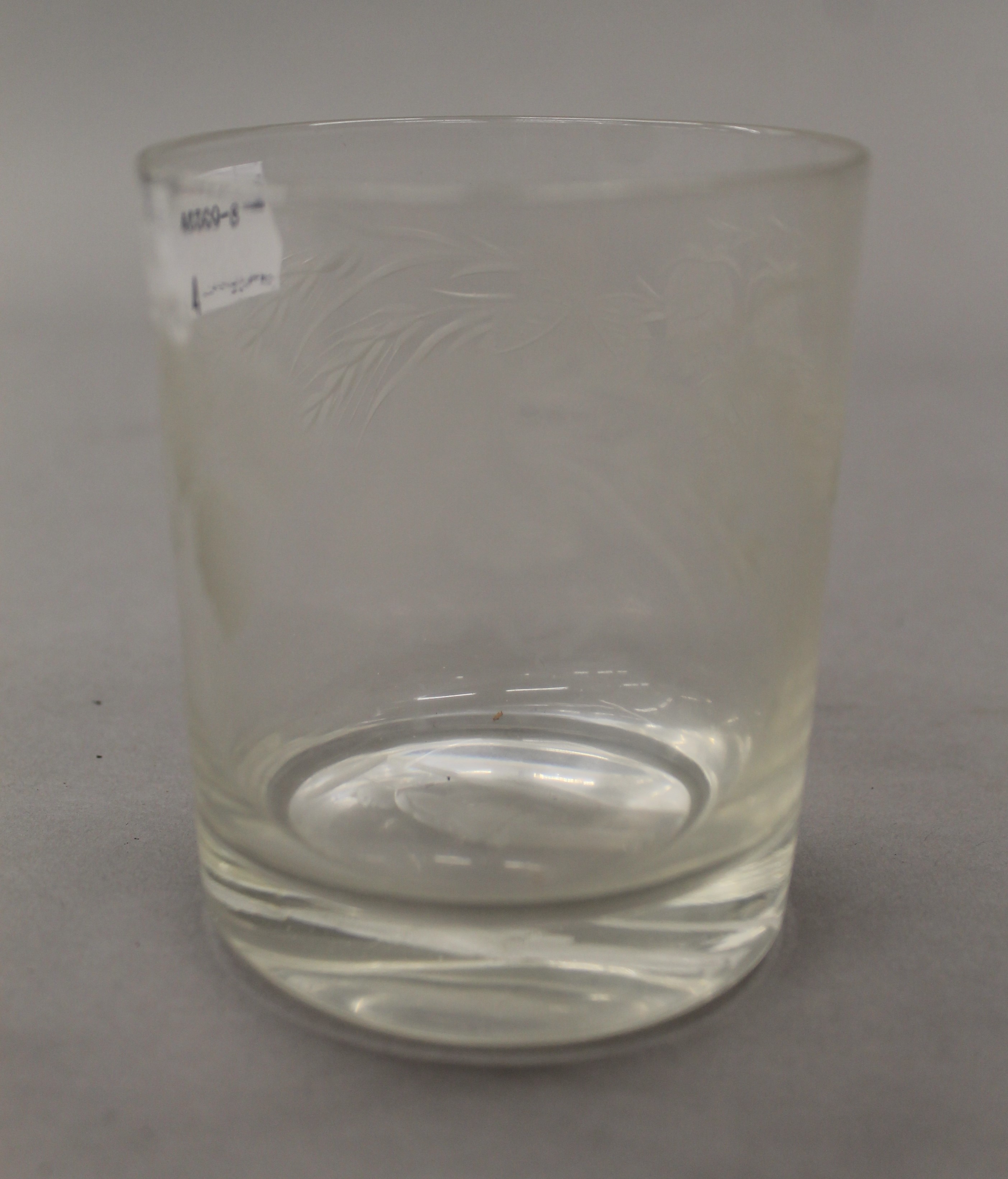 A 19th century engraved glass hangman whiskey tumbler. 9.5 cm high.