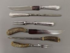 A 925 silver handled carving set and a horn handled carving set.