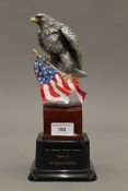 An eagle and flag on stand presented to the Yeoman Warders from the US Element Marcom. 28 cm high.