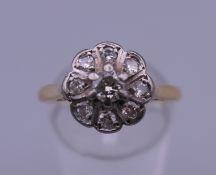 An 18 ct gold diamond cluster ring. Ring size O/P. 3.7 grammes total weight.