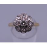 An 18 ct gold diamond cluster ring. Ring size O/P. 3.7 grammes total weight.