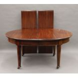 A late 19th/early 20th century mahogany two leaf extending dining table. 239 cm long extended.
