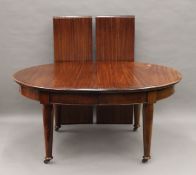 A late 19th/early 20th century mahogany two leaf extending dining table. 239 cm long extended.