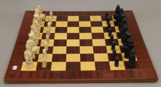 A large chess board and chess set. The board 59 cm wide. The Kings 9.5 cm high.