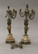 A pair of ormolu cherub form candelabra. 68 cm high.