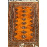 An orange ground wool rug. 183 x 126 cm.