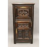 A 19th century carved oak cupboard. 66.5 cm wide.