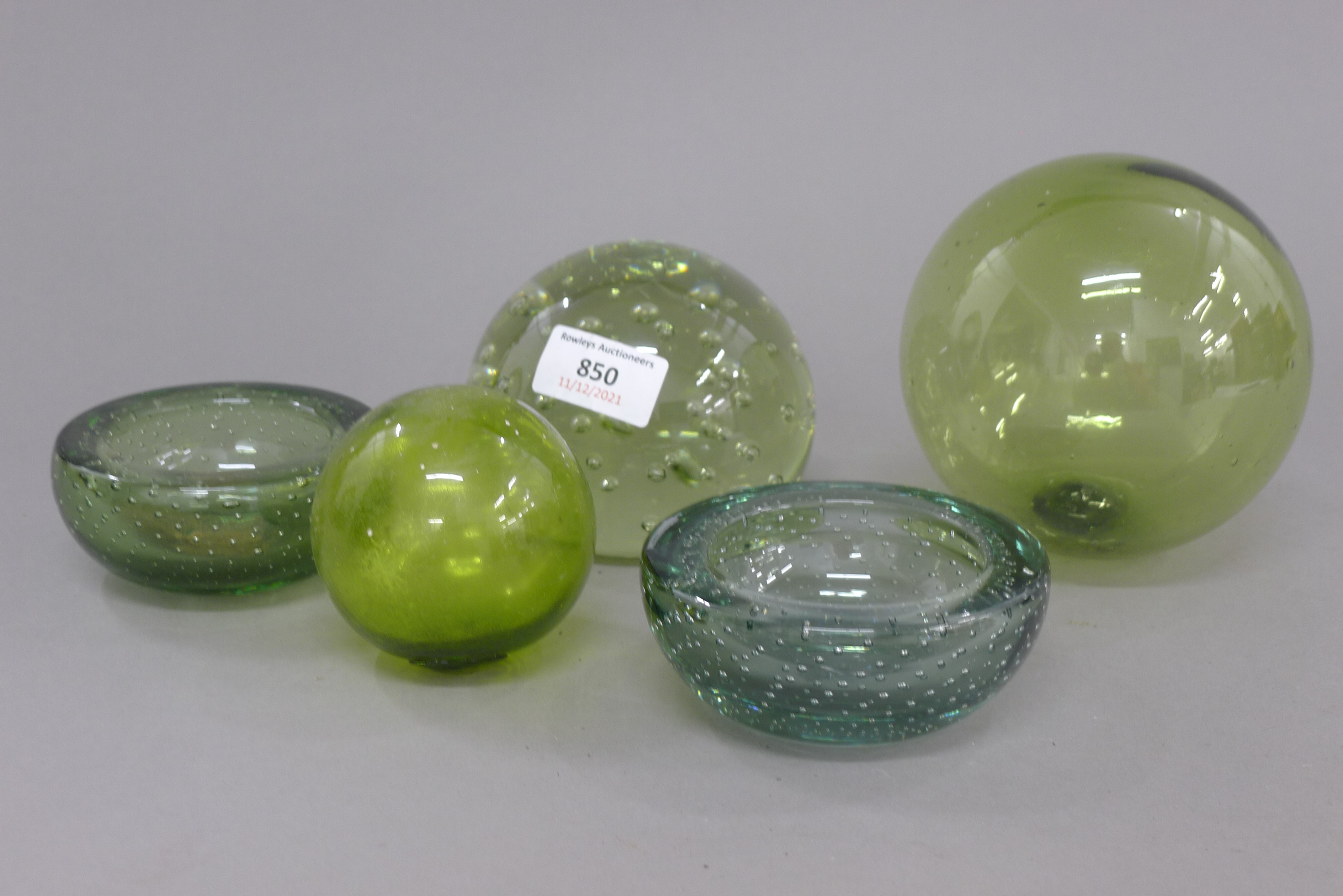 A quantity of green glassware, including a dump weight. 7.5 cm high.
