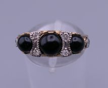 A 9 ct gold onyx and diamond ring. Ring size N.