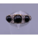 A 9 ct gold onyx and diamond ring. Ring size N.