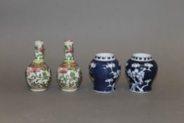 A pair of miniature Canton famille rose vases and a pair of miniature Chinese prunus blossom vases.