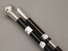 Two silver mounted walking sticks. The largest 91 cm long.