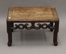 A late 19th/early 20th century Chinese carved hardwood low rectangular stand. 47.5 cm wide.