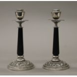 A pair of Oriental silver and ebony candlesticks. Each 19 cm high.