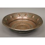 A large repousse copper bowl. 55 cm diameter.