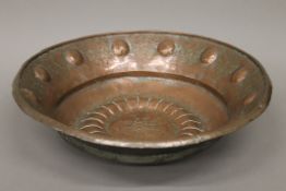 A large repousse copper bowl. 55 cm diameter.