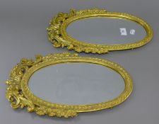 A pair of brass mirrors. 39 cm high.