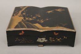 A late 19th/early 20th century Japanese lacquered games box, containing bone and ivory counters.