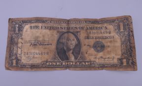 A 1935 A-Series with blue seal silver certificate American one dollar.