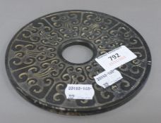 A Chinese bi-disc. 14.5 cm diameter.