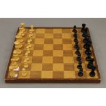A chess set and board, and a part set of draughts.
