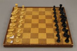 A chess set and board, and a part set of draughts.