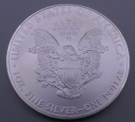A 1 ounce fine silver 2009 USA dollar, in case.