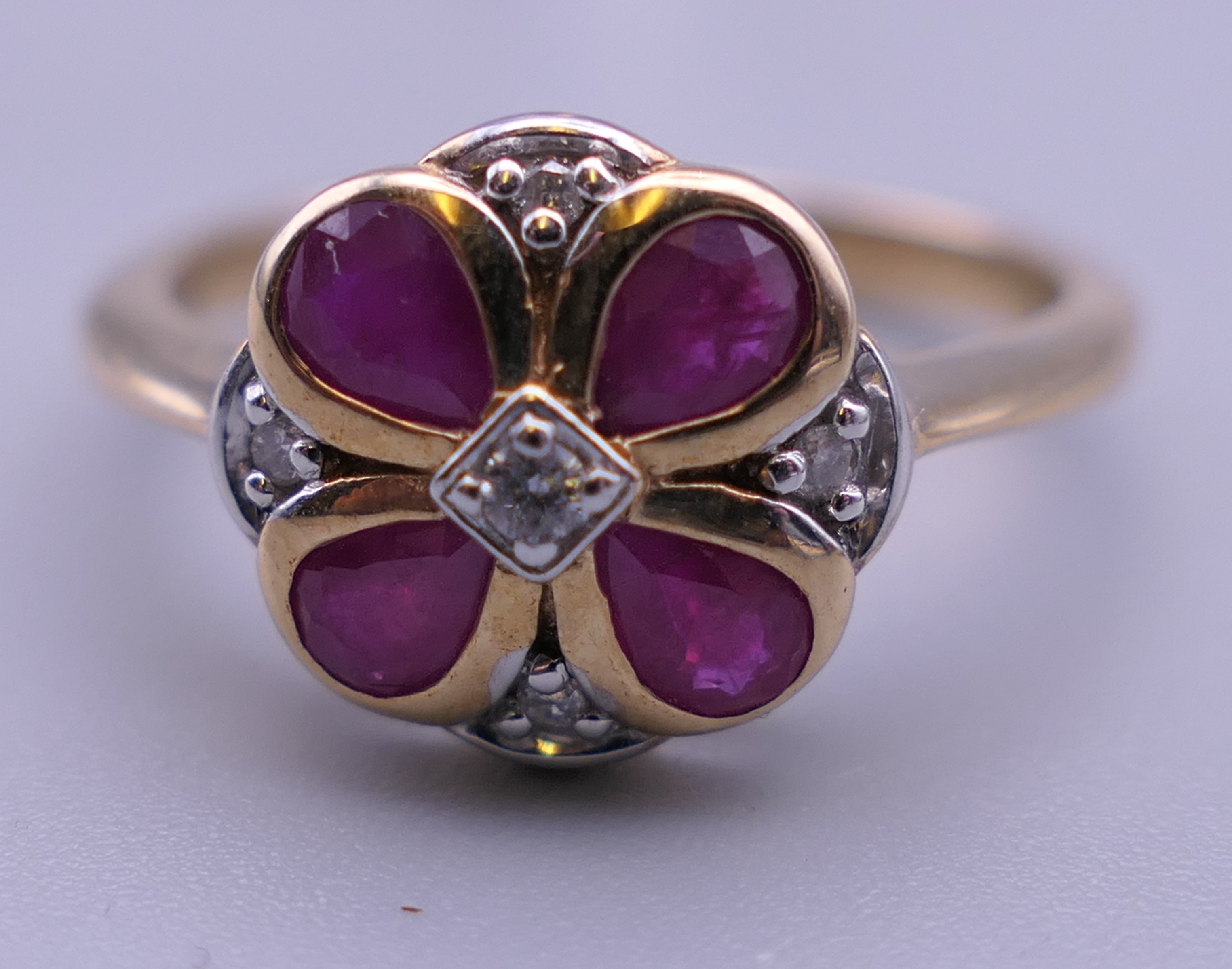 A 9 ct gold ruby and diamond flower ring. Ring size M. - Image 6 of 6