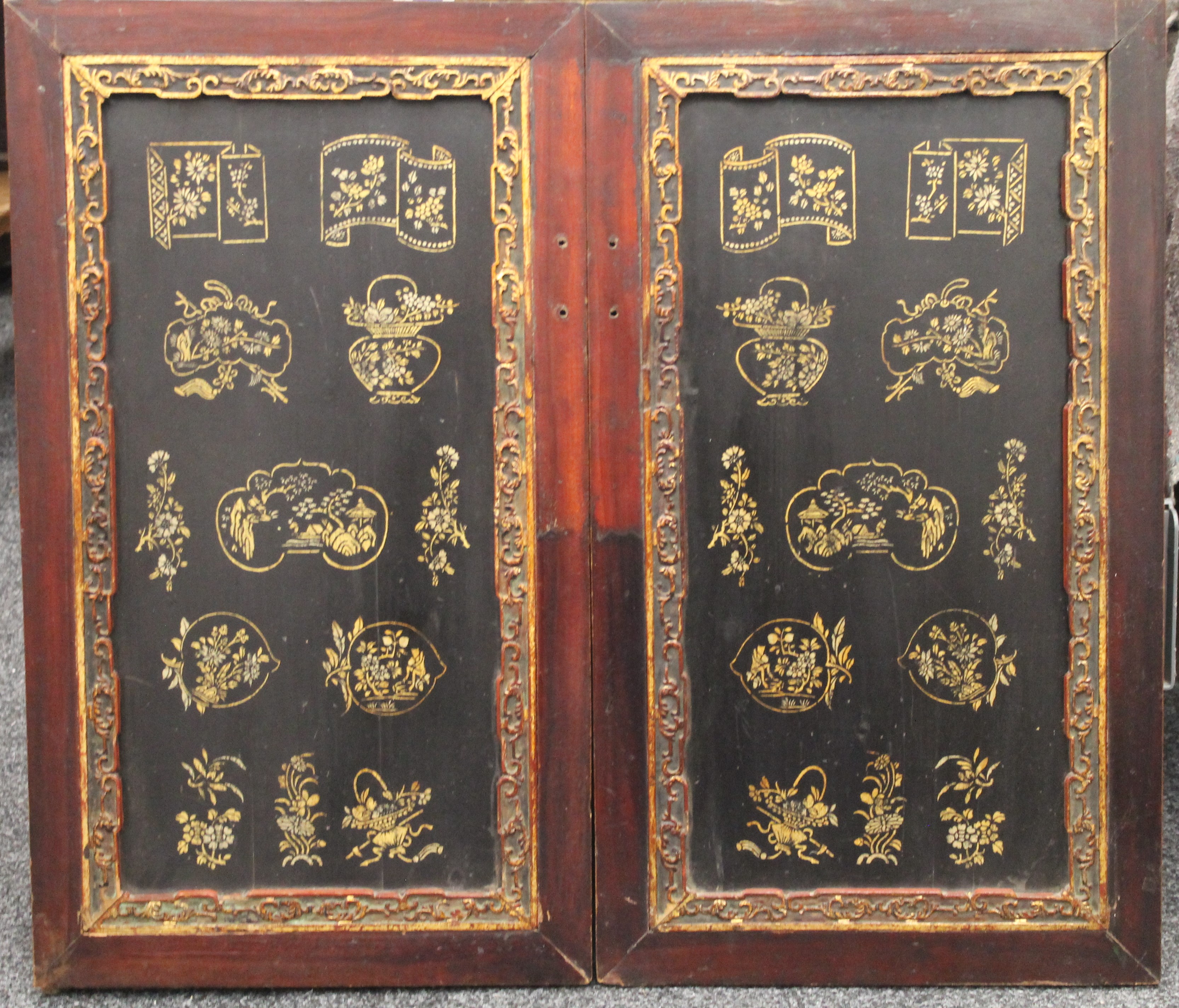 A pair of Chinese lacquered door panels. Each 46 x 80 cm.
