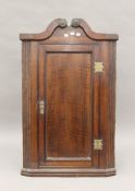 A Georgian oak corner cupboard. 68 cm wide.