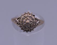A 9 ct gold diamond cluster ring. 1/4 carat diamond weight. Ring size K/L. 2.5 grammes total weight.
