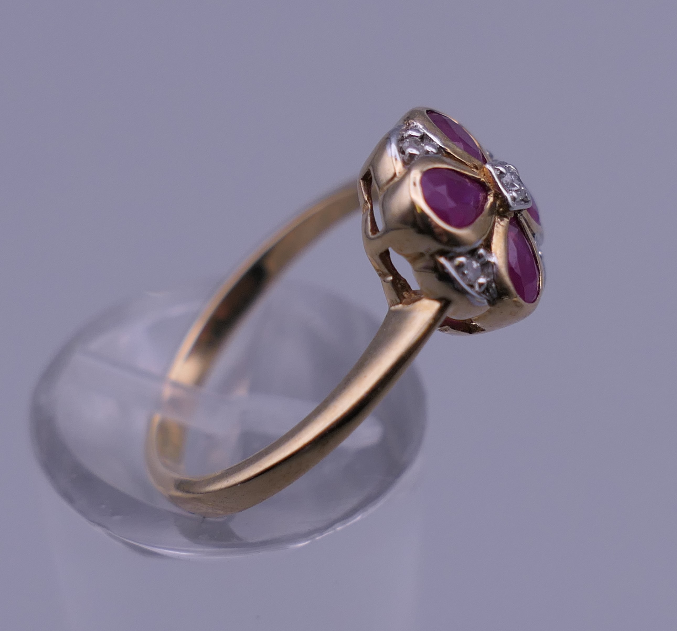 A 9 ct gold ruby and diamond flower ring. Ring size M. - Image 3 of 6