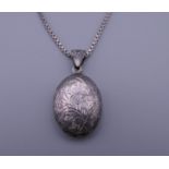 A silver locket on chain. The locket 3.5 cm high. 9.3 grammes.