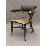 A Victorian leather upholstered mahogany desk chair. 64 cm wide.