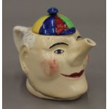 A Simple Simon porcelain teapot. 20 cm long.