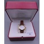 A boxed 18 ct gold Cartier gentleman's wristwatch. 4 cm wide overall.