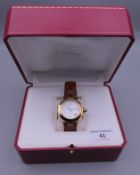 A boxed 18 ct gold Cartier gentleman's wristwatch. 4 cm wide overall.
