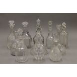 A quantity of various cut glass decanters.