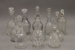 A quantity of various cut glass decanters.