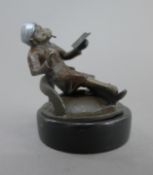 A cold painted bronze model of a smoking monkey. 6.5 cm high.