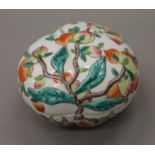 A Chinese porcelain box and cover formed as and decorated with peaches. 12.5 cm wide.