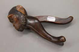 A 19th century treen nutcracker formed as a monkey. 20 cm long.