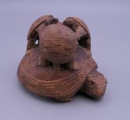A Japanese carved wooden tortoise group. 6.5 cm high.
