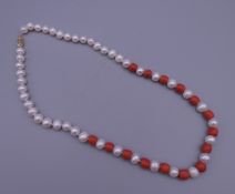 A 14 ct gold coral and pearl necklace. 42 cm long.