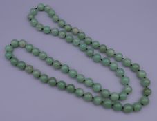 A string of jade beads. 90 cm long.